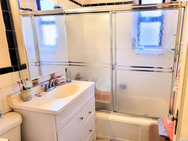 full bathroom featuring vanity, toilet, and enclosed tub / shower combo