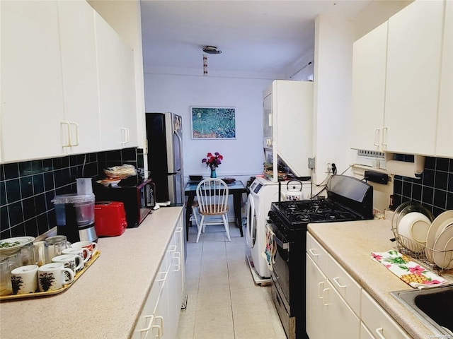 kitchen featuring tasteful backsplash, white cabinets, light tile patterned flooring, and appliances with stainless steel finishes