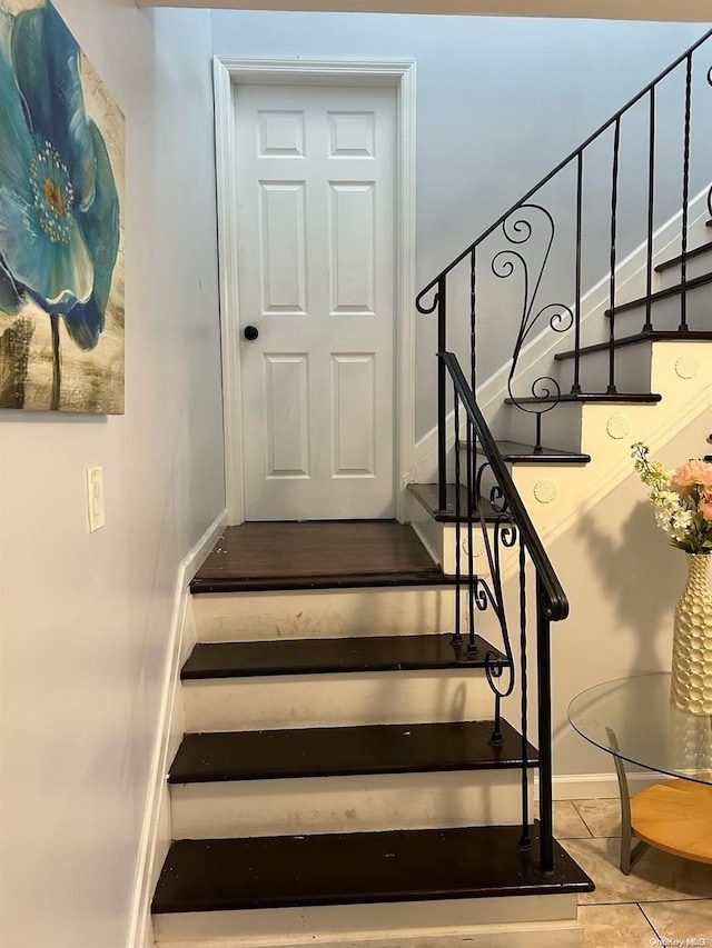 stairs featuring tile patterned flooring