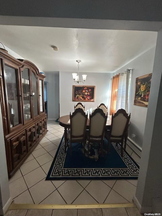 dining space with light tile patterned floors, a baseboard heating unit, and an inviting chandelier