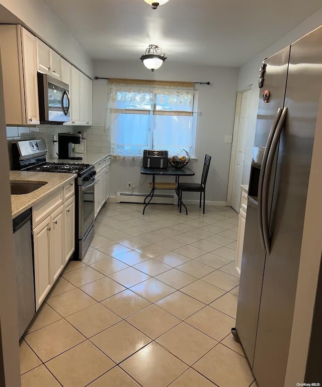 136 Acorn Ave, Central Islip, NY 11722 - kitchen with stainless steel appliances, a baseboard radiator, white cabinets, tasteful backsplash, and light tile patterned flooring