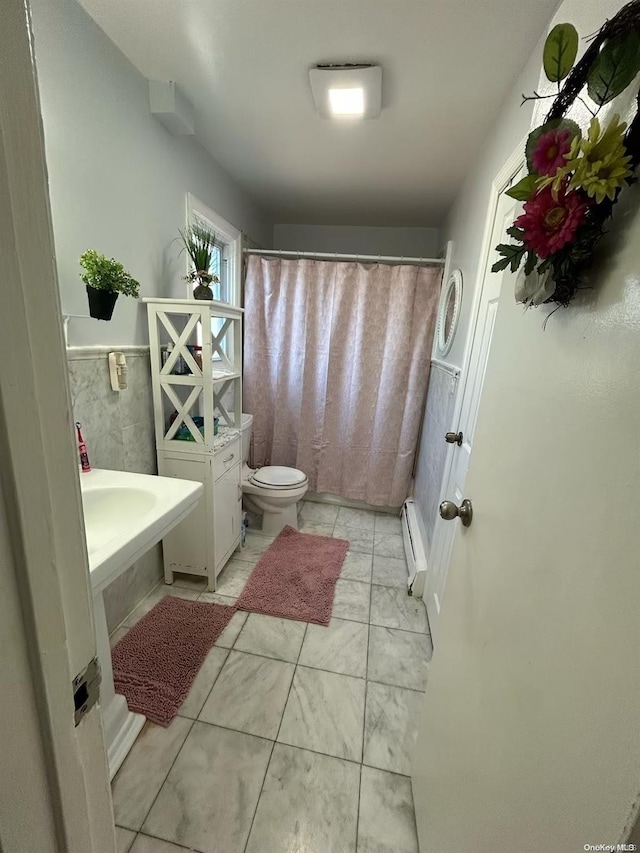 bathroom featuring walk in shower, toilet, and baseboard heating