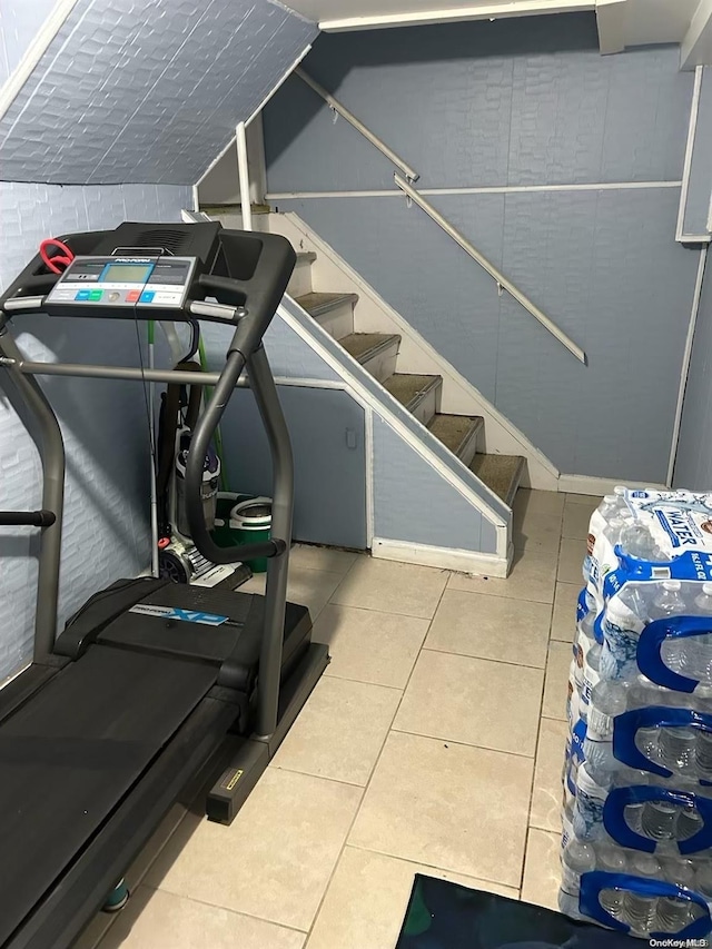 workout area featuring light tile patterned floors