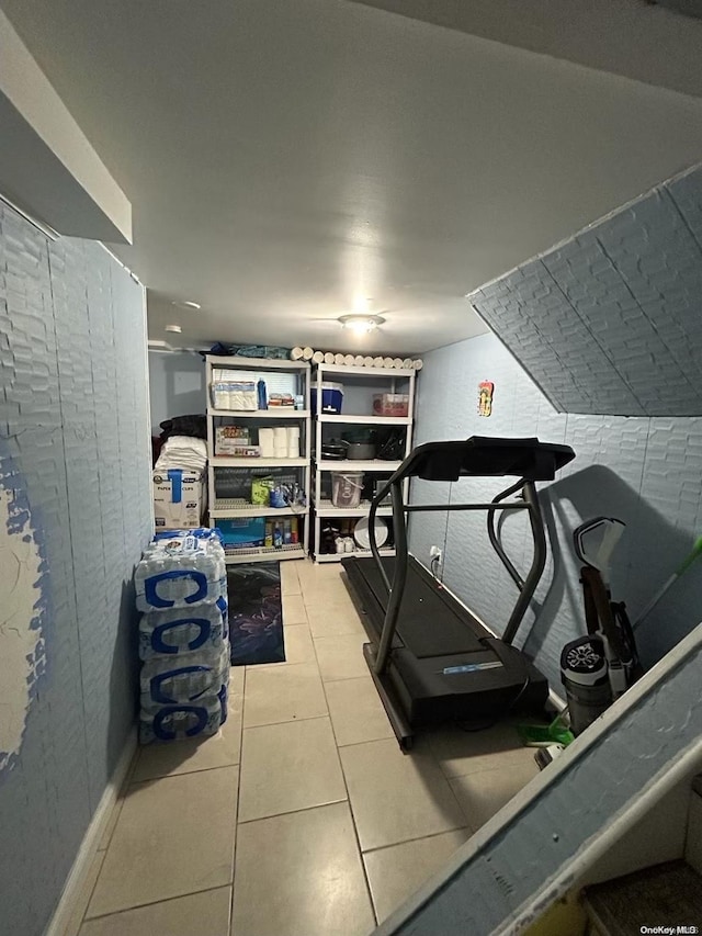 exercise room with light tile patterned floors