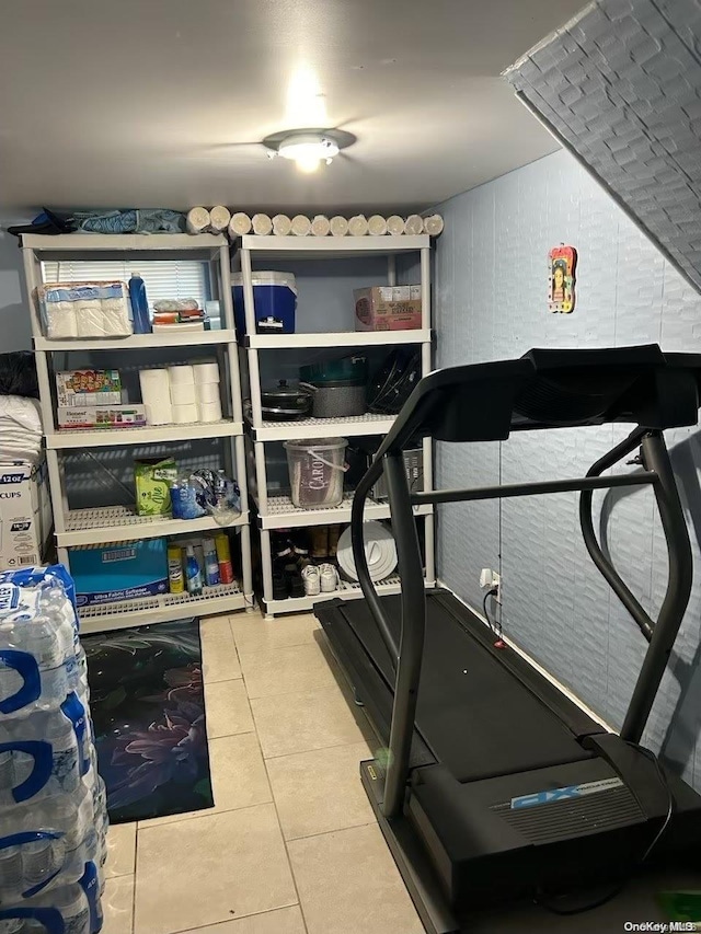 workout room featuring light tile patterned floors