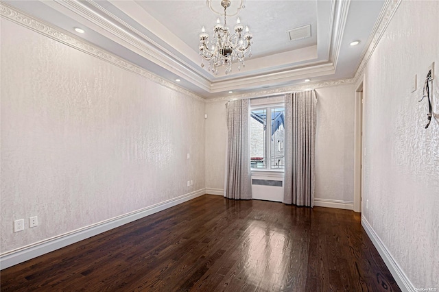 unfurnished room with dark hardwood / wood-style floors, a raised ceiling, ornamental molding, and a chandelier