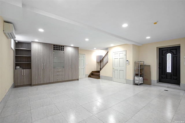 entrance foyer featuring an AC wall unit and light tile patterned floors