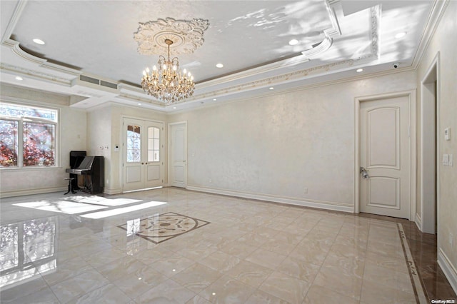 interior space featuring a notable chandelier, ornamental molding, and a tray ceiling