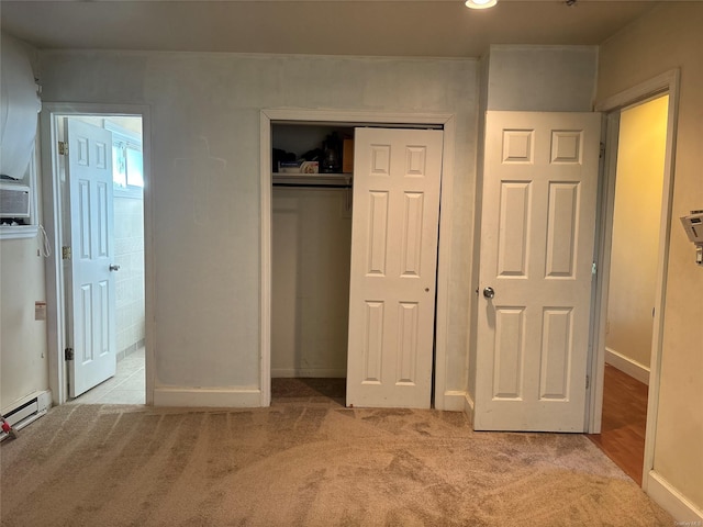 unfurnished bedroom with light carpet, a closet, and baseboards