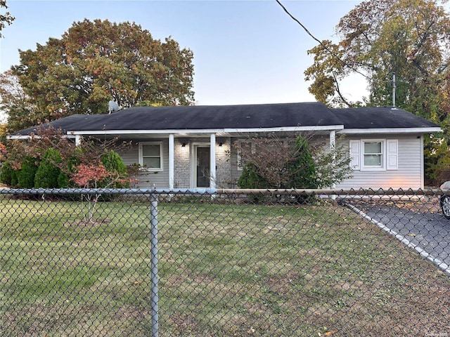 view of front of home with a fenced front yard and a front lawn