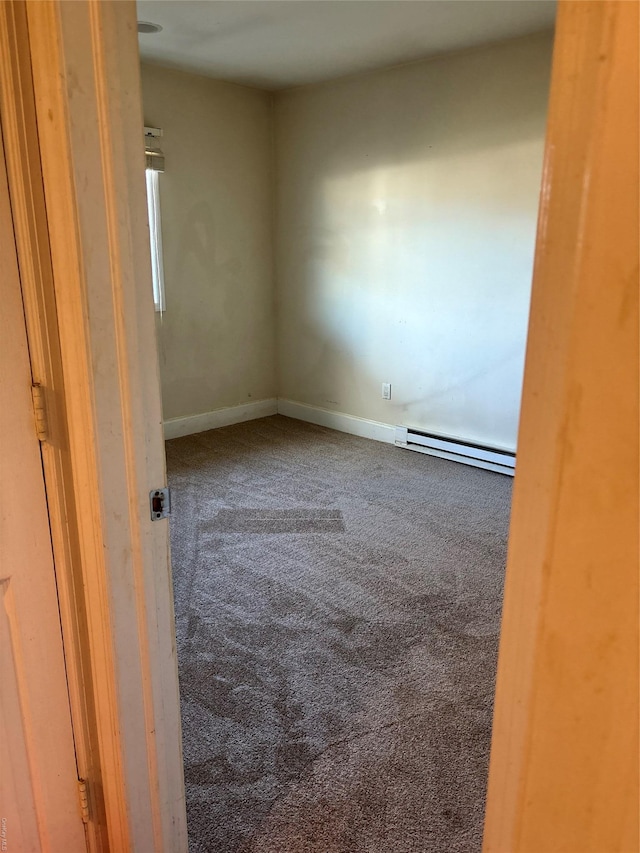 unfurnished room featuring baseboards, carpet floors, and baseboard heating