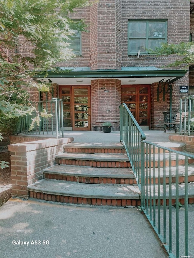 doorway to property featuring french doors and covered porch