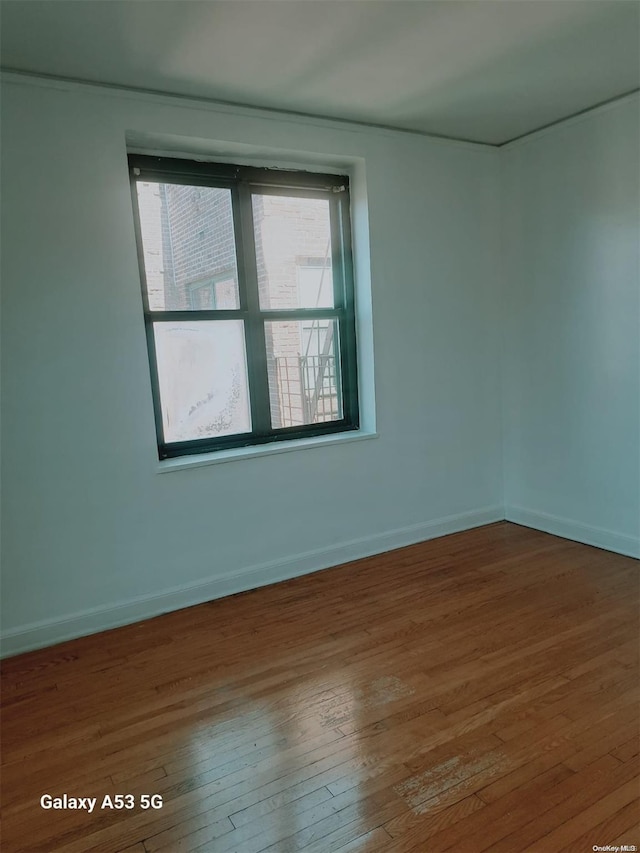 spare room with hardwood / wood-style flooring