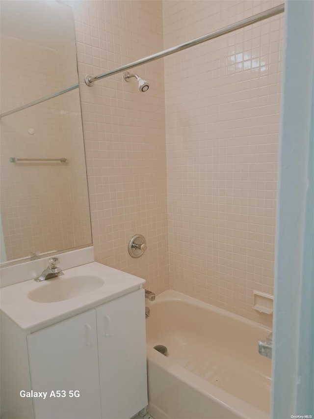 bathroom with vanity and tiled shower / bath combo