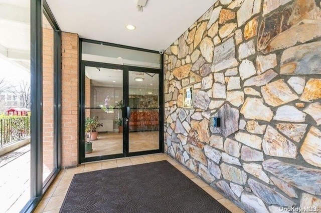 doorway to outside featuring light tile patterned floors and plenty of natural light