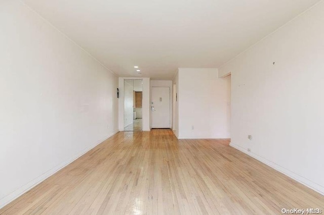 spare room featuring light wood-type flooring