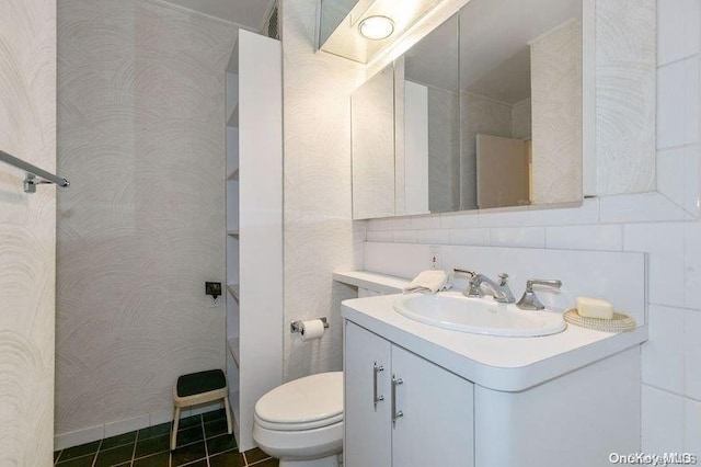 bathroom featuring tile patterned floors, vanity, and toilet