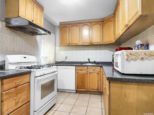 kitchen featuring decorative backsplash, light tile patterned floors, white appliances, and sink