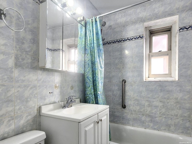 full bathroom featuring vanity, shower / bath combo, tile walls, and toilet