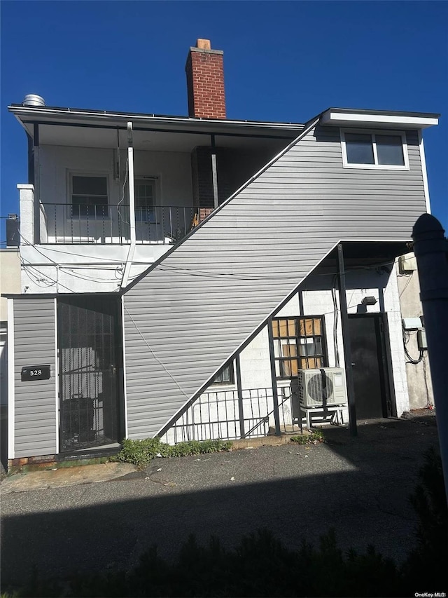 back of property with a balcony