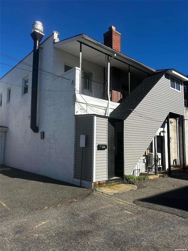 rear view of house featuring a balcony