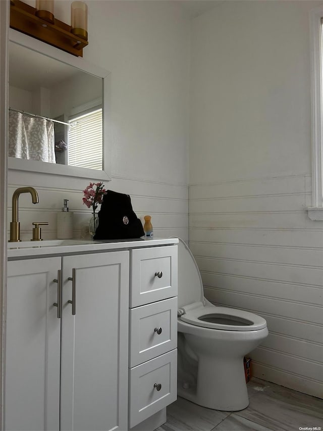 bathroom featuring vanity and toilet