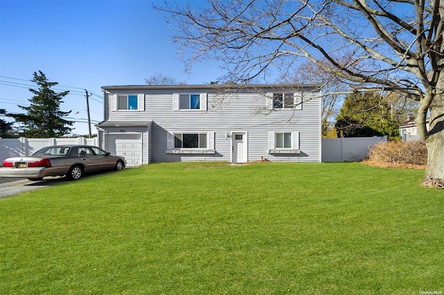 view of front of home featuring a garage and a front lawn