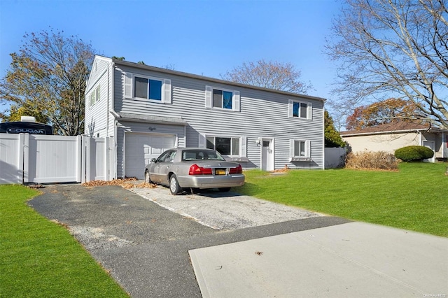 back of house featuring a garage and a yard