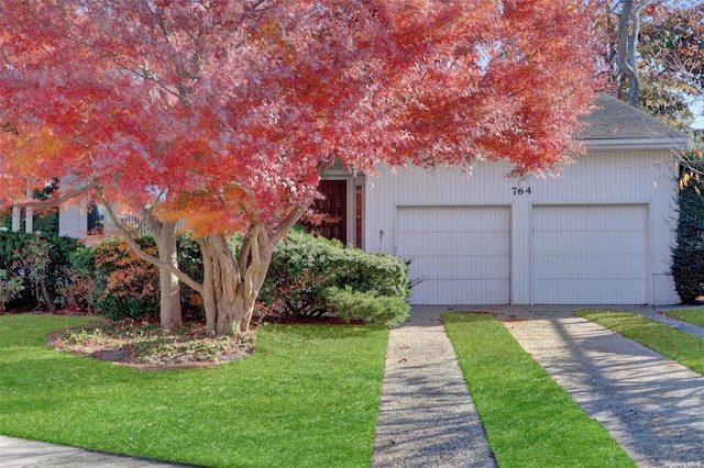 view of front of property with a garage and a front yard