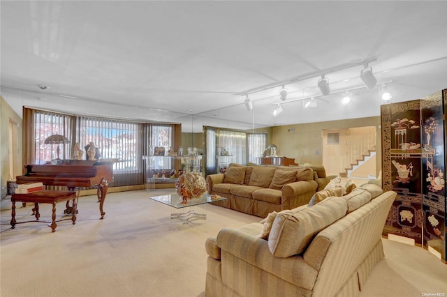 living room featuring light carpet and track lighting