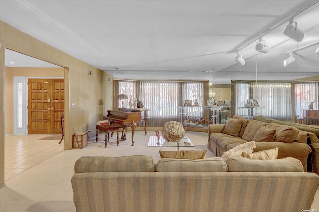 tiled living room with track lighting and plenty of natural light