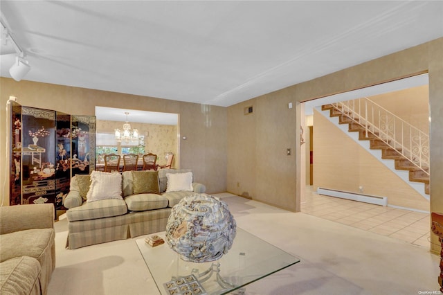 living room featuring carpet flooring, a notable chandelier, baseboard heating, and track lighting