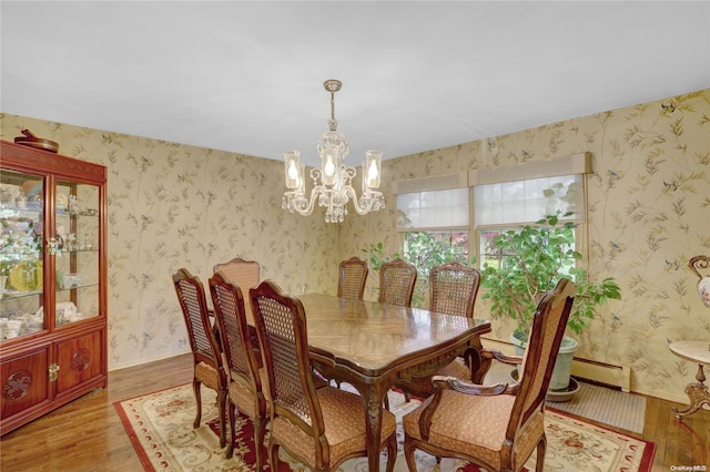 dining room featuring baseboard heating, a chandelier, and light hardwood / wood-style floors