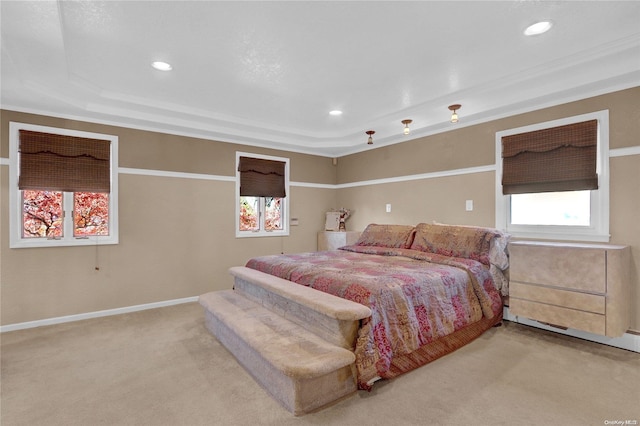 bedroom featuring carpet, a tray ceiling, and ornamental molding