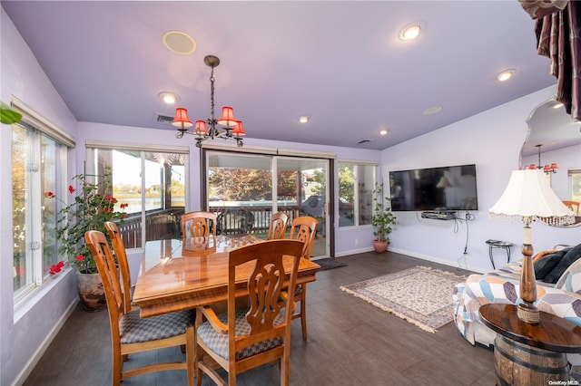 dining room with plenty of natural light, dark wood-type flooring, and lofted ceiling