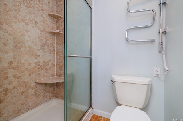 bathroom featuring tile patterned floors, toilet, and walk in shower