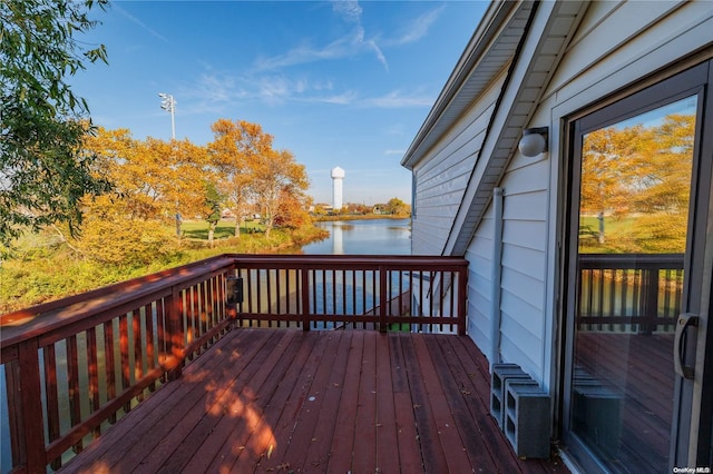 wooden terrace featuring a water view