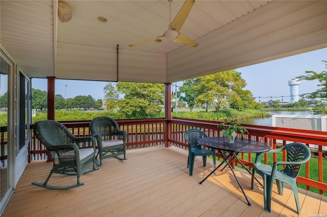 wooden deck featuring a water view and ceiling fan