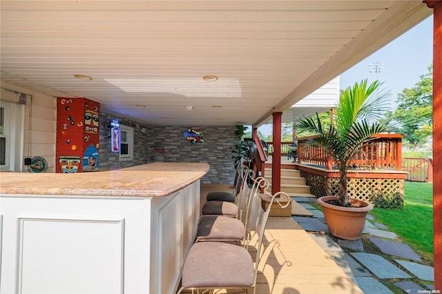 view of patio featuring a wooden deck and a bar