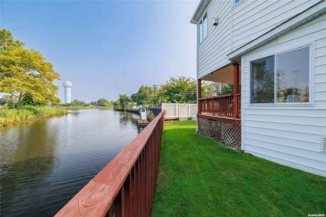 exterior space with a lawn and a water view