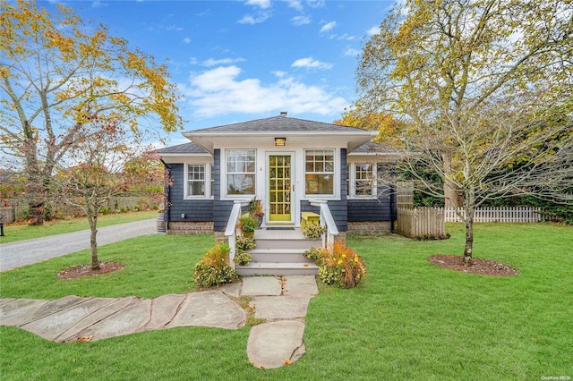 bungalow-style house with a front lawn