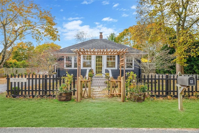 rear view of house featuring a lawn and a pergola