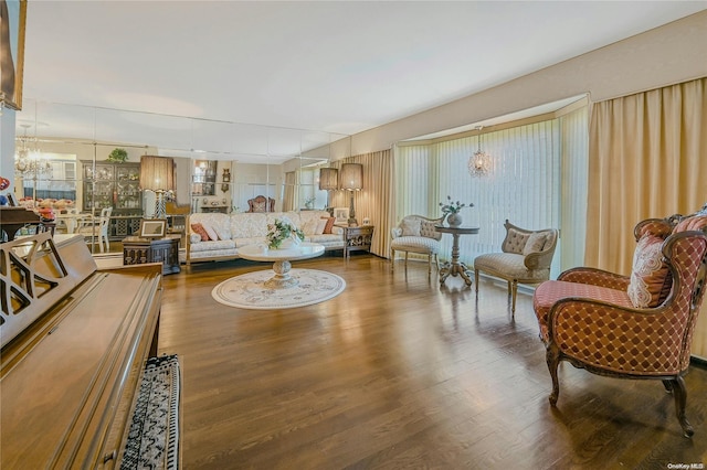 living room with hardwood / wood-style floors and a notable chandelier