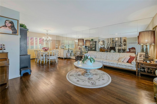 living room featuring dark wood-type flooring and a notable chandelier