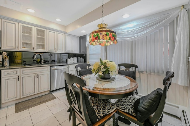 tiled dining space with baseboard heating and sink