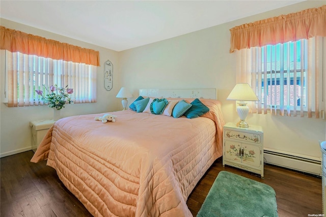 bedroom with dark hardwood / wood-style flooring, multiple windows, and a baseboard radiator