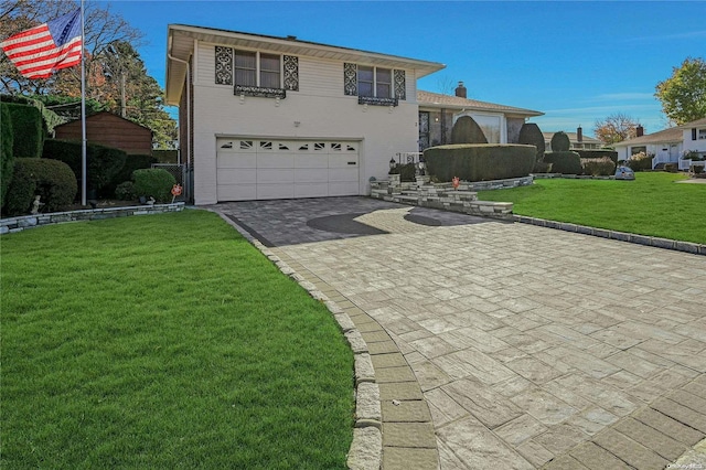 split level home featuring a front yard and a garage