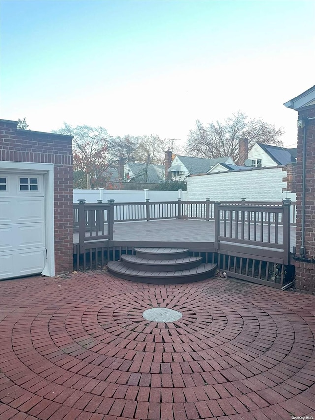 view of patio featuring a garage and a deck