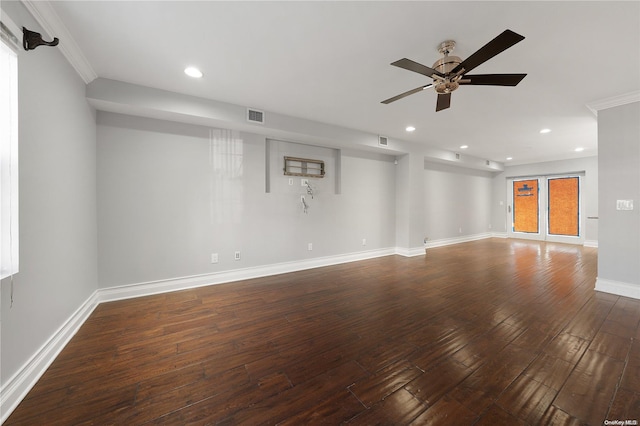 unfurnished living room featuring dark hardwood / wood-style flooring, ceiling fan, and crown molding