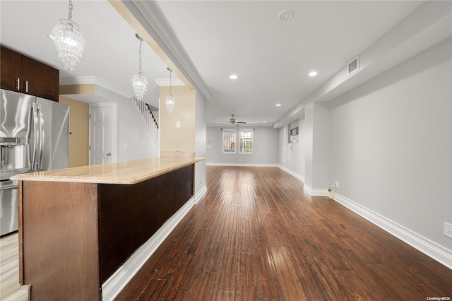 kitchen featuring hanging light fixtures, stainless steel fridge with ice dispenser, dark hardwood / wood-style floors, crown molding, and ceiling fan with notable chandelier